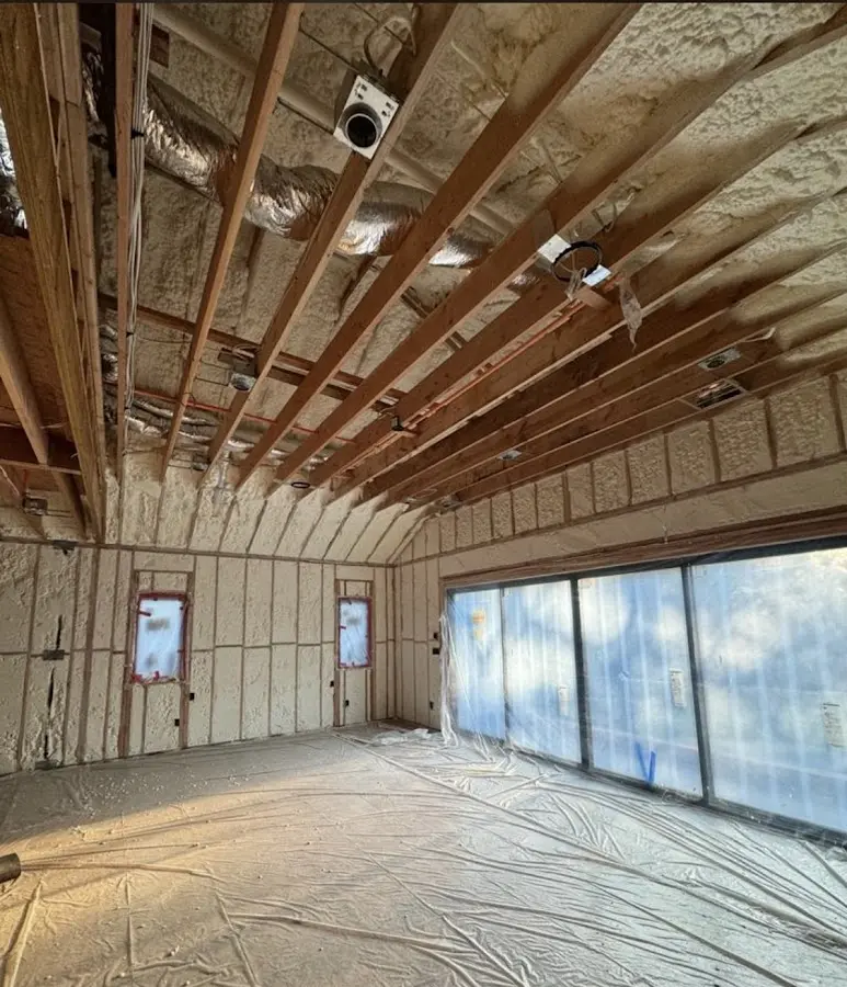 Interior walls and ceiling insulated with spray foam during new construction in East Grand Rapids
